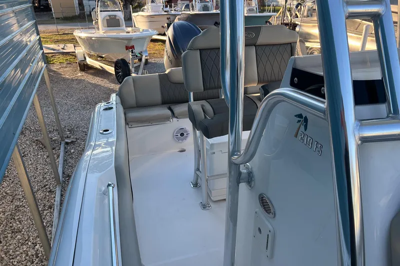 Slide: The Image of 2026 Key West 219 FS boat interior with seating and console details. - 19