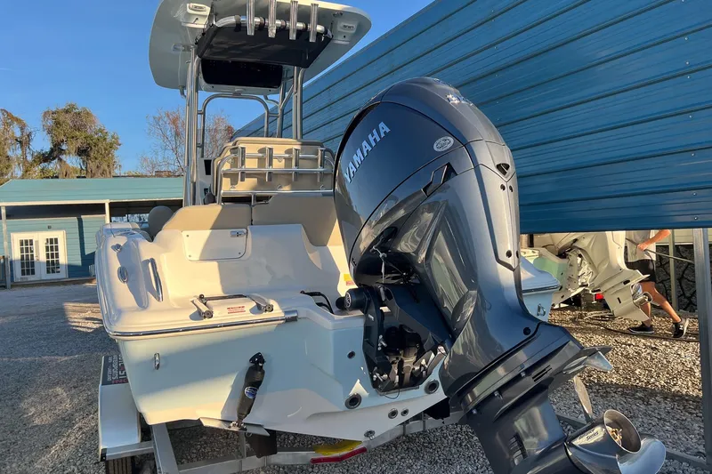 Slide: The Image of 2026 Key West 219 FS boat with Yamaha outboard motor, parked outdoors. - 3