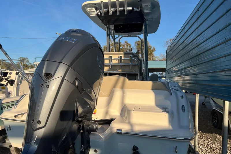 Slide: The Image of 2026 Key West 219 FS boat with powerful outboard motor, docked outdoors. - 4