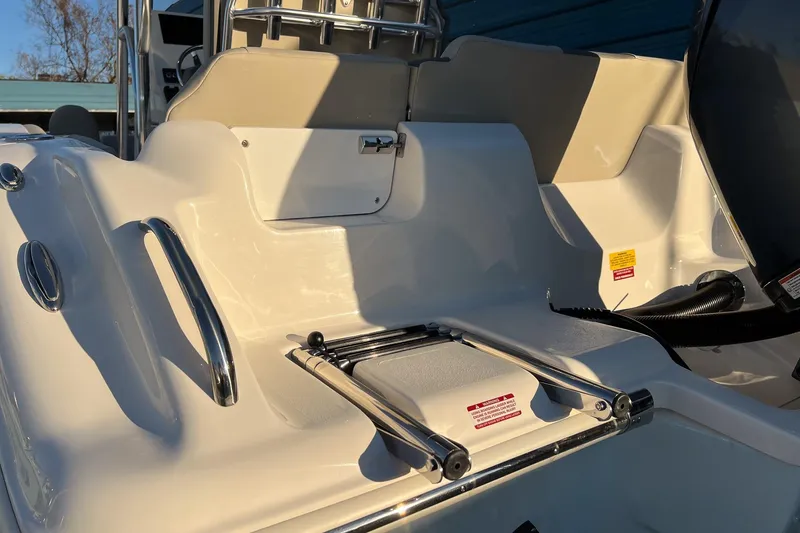 Slide: The Image of 2026 Key West 219 FS boat interior with ladder and seating area. - 5