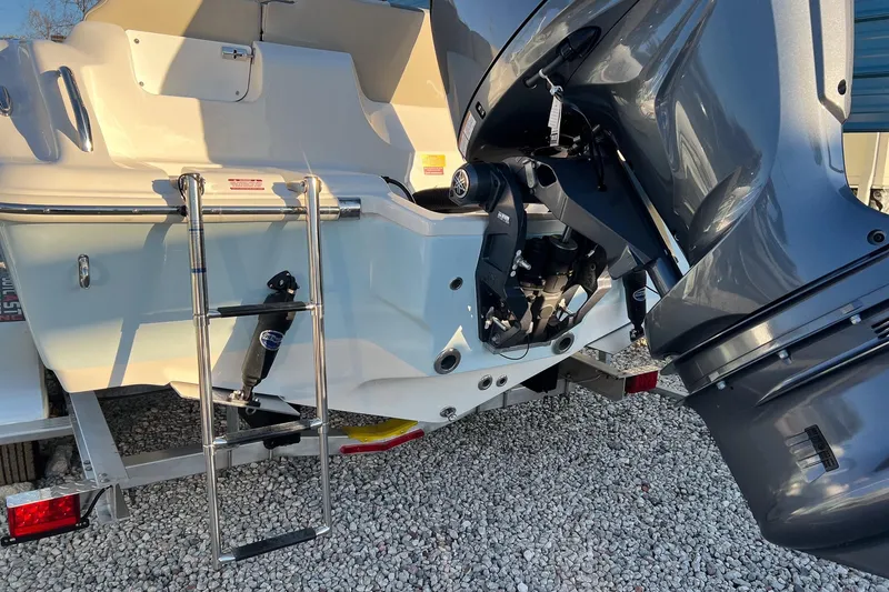 Slide: The Image of 2026 Key West 219 FS boat rear view with motor and ladder. - 6