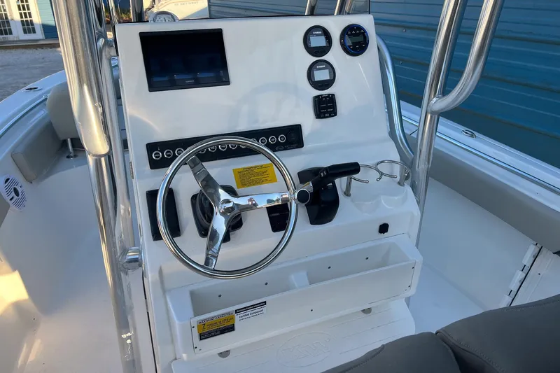 Slide: The Image of 2026 Key West 219 FS boat console with steering wheel and gauges. - 7