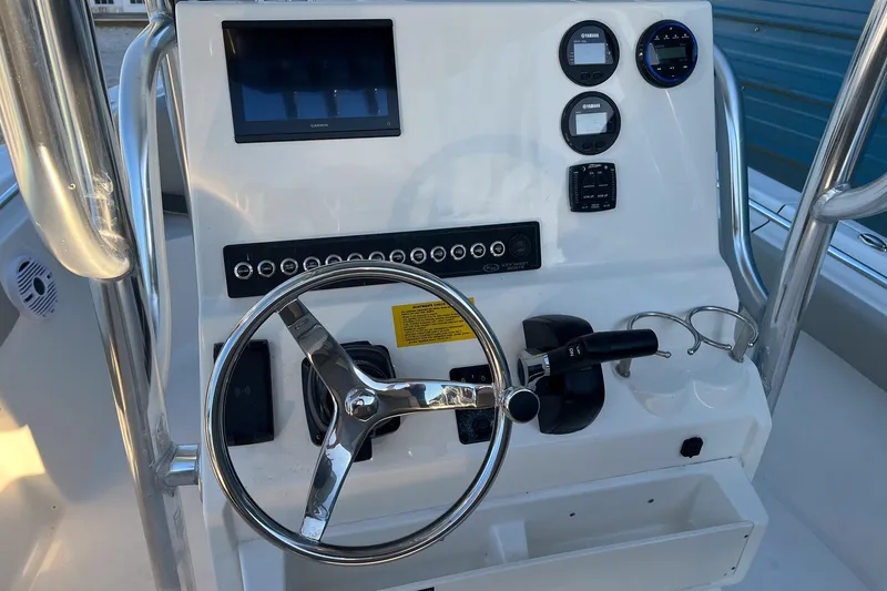 Slide: The Image of Steering console of 2026 Key West 219 FS boat with modern controls and display. - 8