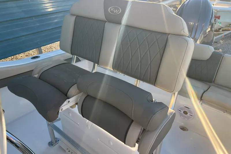 Slide: The Image of 2026 Key West 219 FS boat seating with gray upholstery and diamond stitching. - 9