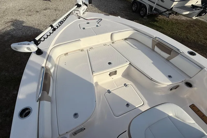 Slide: The Image of 2023 Robalo 226 Cayman boat deck with storage compartments and trolling motor. - 10