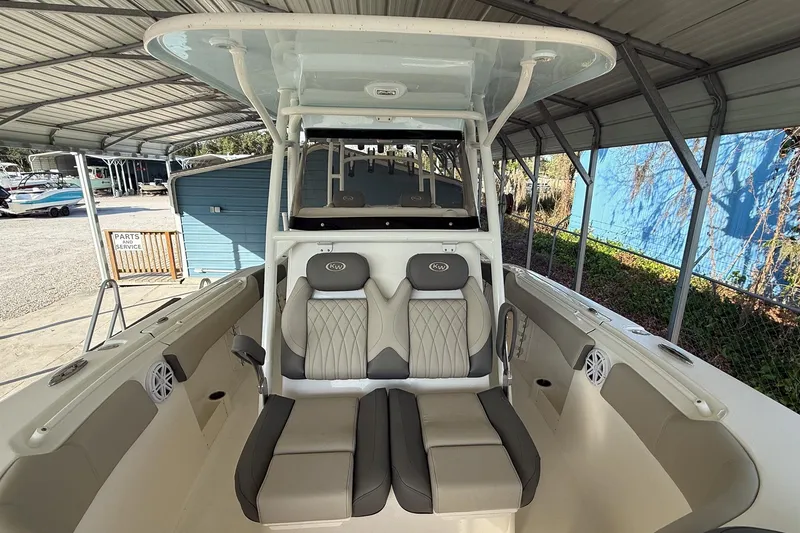 Slide: The Image of 2025 Key West 291 FS boat interior with cushioned seating under a canopy. - 7