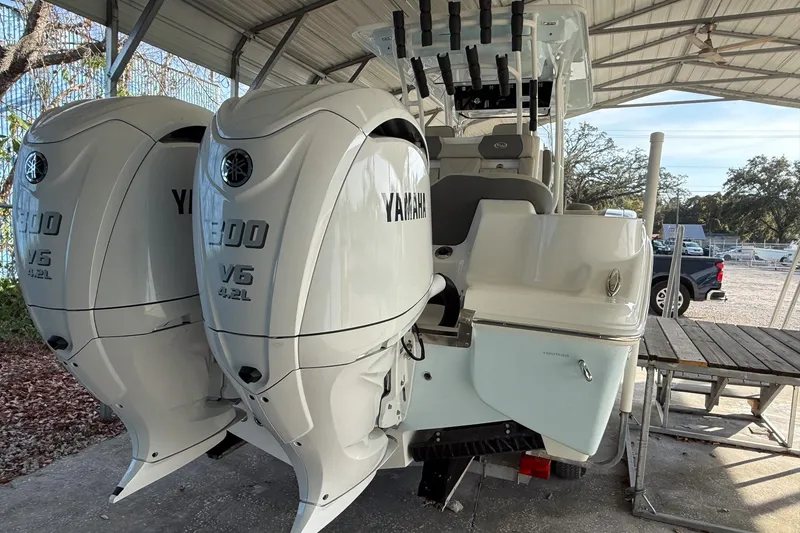 Slide: The Image of 2025 Key West 291 FS boat with twin Yamaha V6 300 engines under a canopy. - 8