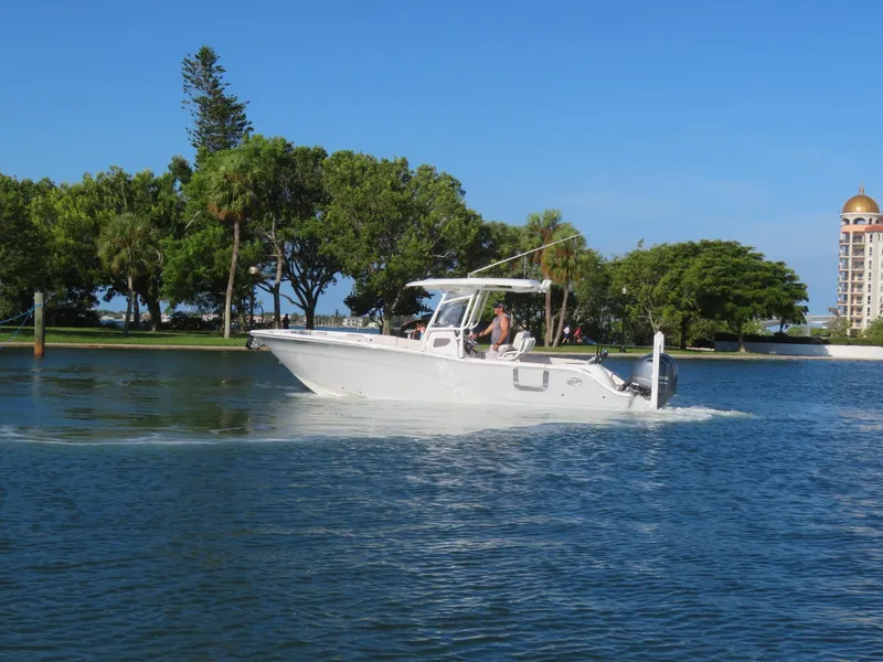 Slide: The Image of 2022 Sea Fox 268 Commander on calm water near trees. - 7