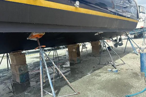 Slide: The Image of 2006 Navigator 5400 yacht on stands for maintenance, showing hull and propeller. - 35