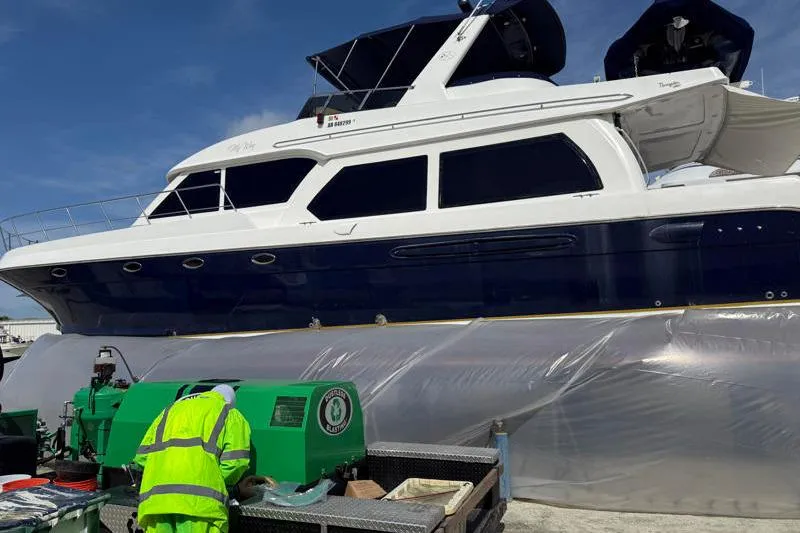 Slide: The Image of 2006 Navigator 5400 yacht undergoing maintenance with worker in high-visibility clothing. - 36