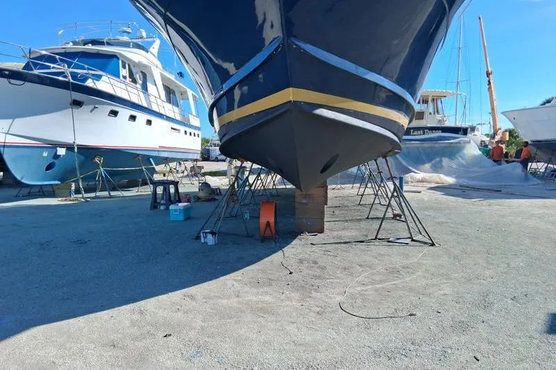 Slide: The Image of 2006 Navigator 5400 yacht in dry dock, surrounded by other boats under maintenance. - 38