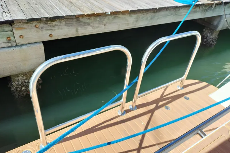 Slide: The Image of Stainless steel boat railings on a Navigator 5400 yacht, docked by a wooden pier. - 42