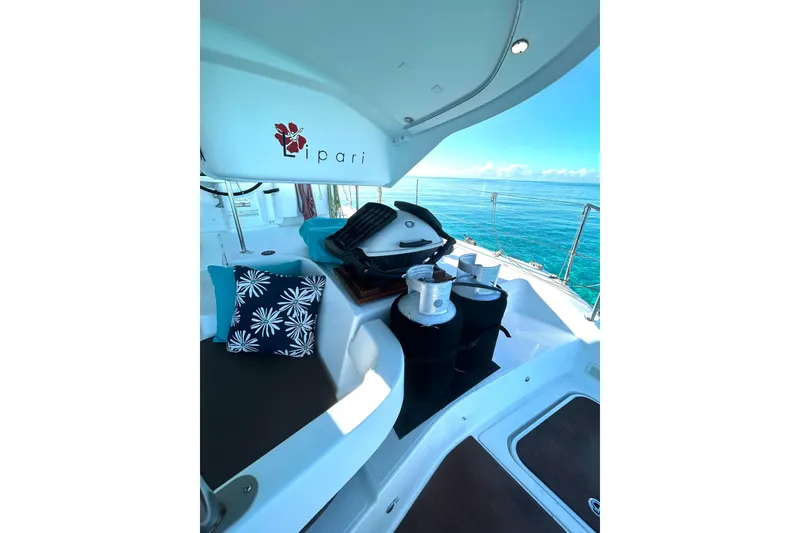 Slide: The Image of 2012 Fountaine Pajot Lipari yacht deck with ocean view, featuring seating and nautical equipment. - 12