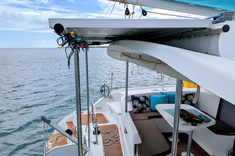 Slide: The Image of 2012 Fountaine Pajot Lipari catamaran with deck seating, ocean view, and colorful decorations. - 13