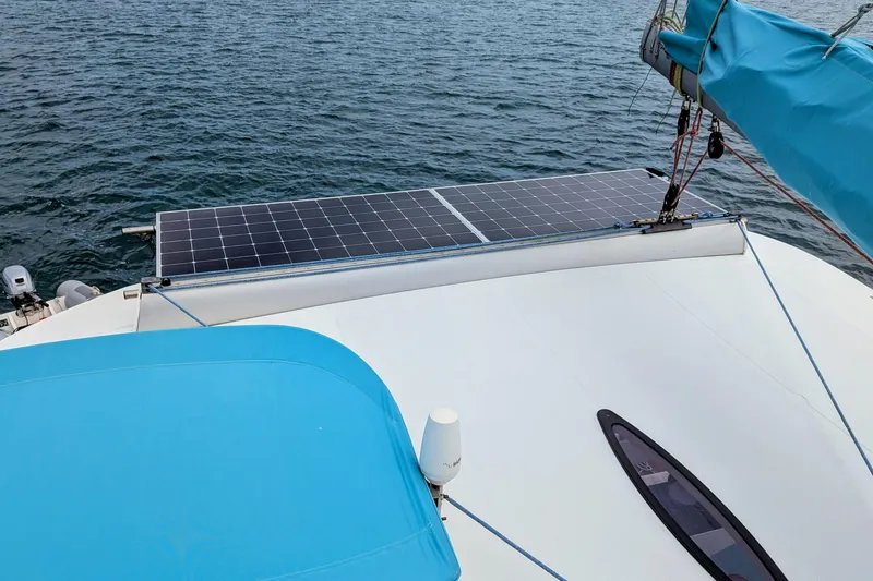 Slide: The Image of 2012 Fountaine Pajot Lipari catamaran with solar panels on deck, sailing on open water. - 14