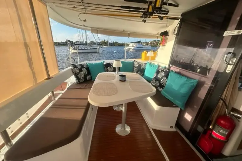 Slide: The Image of 2012 Fountaine Pajot Lipari catamaran interior with cozy seating and scenic marina view. - 17