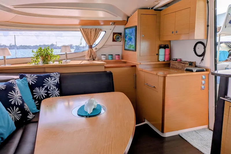 Slide: The Image of Interior of 2012 Fountaine Pajot Lipari Owners Version catamaran, featuring cozy dining area and modern decor. - 20