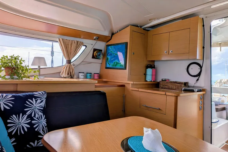 Slide: The Image of Interior of 2012 Fountaine Pajot Lipari Owners Version catamaran, featuring cozy seating and nautical decor. - 23