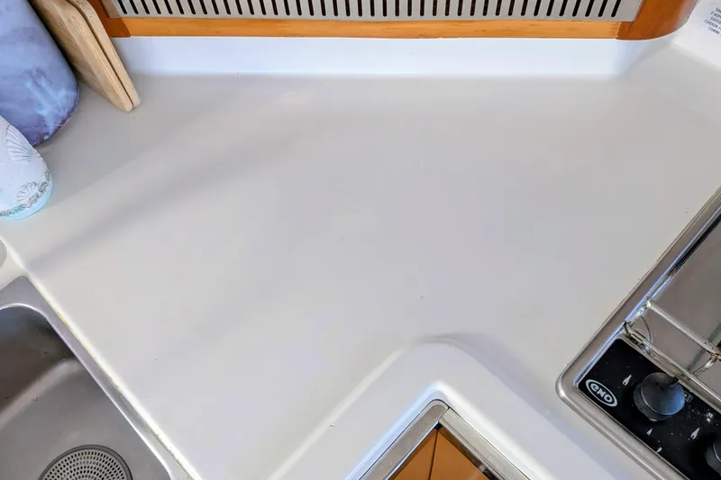 Slide: The Image of 2012 Fountaine Pajot Lipari Owners Version kitchen countertop with sink and stove. - 26