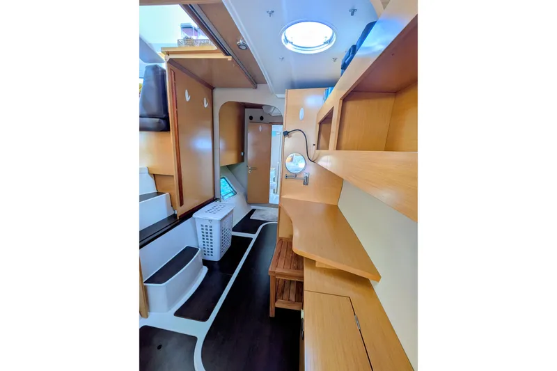 Slide: The Image of Interior of 2012 Fountaine Pajot Lipari catamaran, featuring wooden shelves and modern design. - 30
