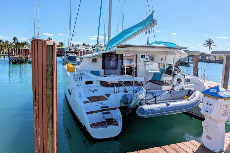 Slide: The Image of 2012 Fountaine Pajot Lipari catamaran docked in a sunny marina with inflatable dinghy. - 5