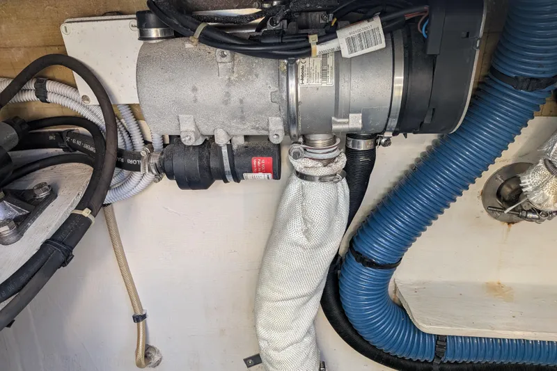 Slide: The Image of Engine compartment of a 2012 Fountaine Pajot Lipari catamaran, showing mechanical components and hoses. - 56