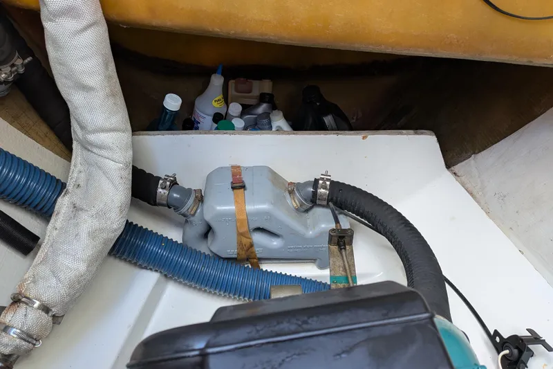 Slide: The Image of Engine compartment of 2012 Fountaine Pajot Lipari with hoses and maintenance supplies. - 57