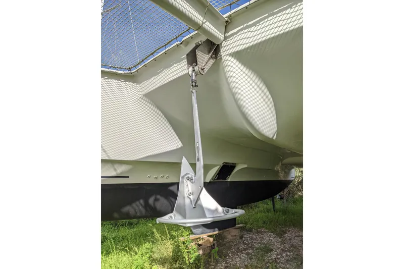 Slide: The Image of 2012 Fountaine Pajot Lipari catamaran anchor detail with netting and hull visible. - 58