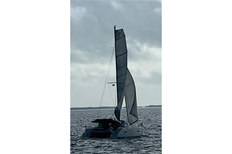 Slide: The Image of 2012 Fountaine Pajot Lipari catamaran sailing on open water under cloudy skies. - 7
