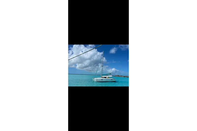 Slide: The Image of 2012 Fountaine Pajot Lipari catamaran sailing on clear turquoise waters under a blue sky. - 8