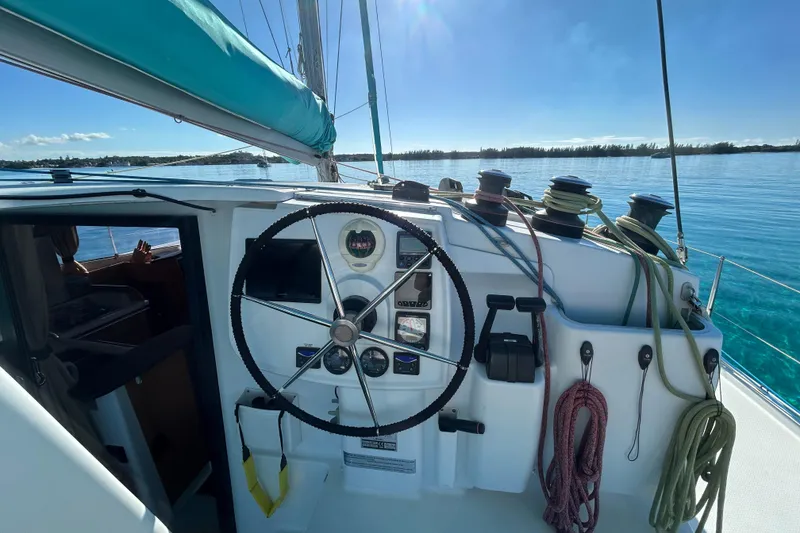 Slide: The Image of Helm of 2012 Fountaine Pajot Lipari catamaran with ropes and clear ocean view. - 9