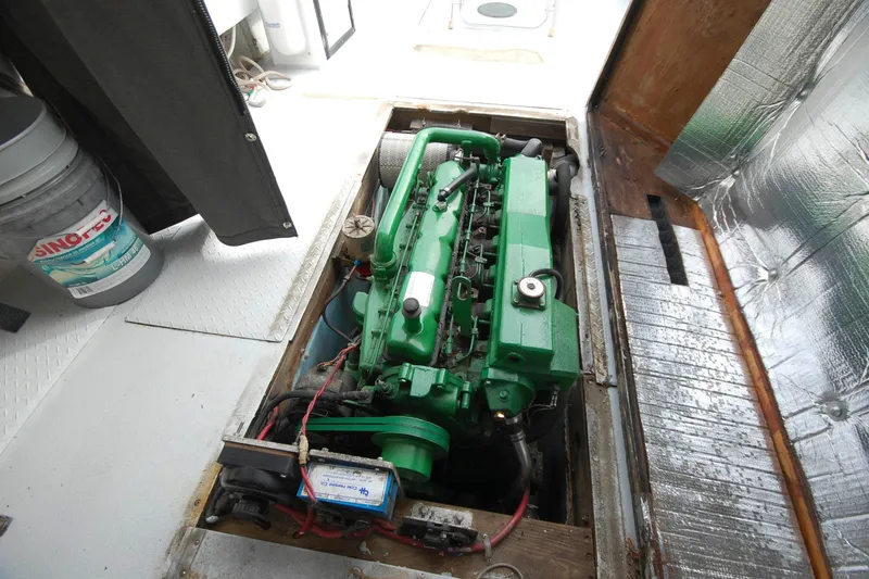 Slide: The Image of Green engine inside a 1998 Custom Stan Haven 30 boat, with visible wiring and components. - 10