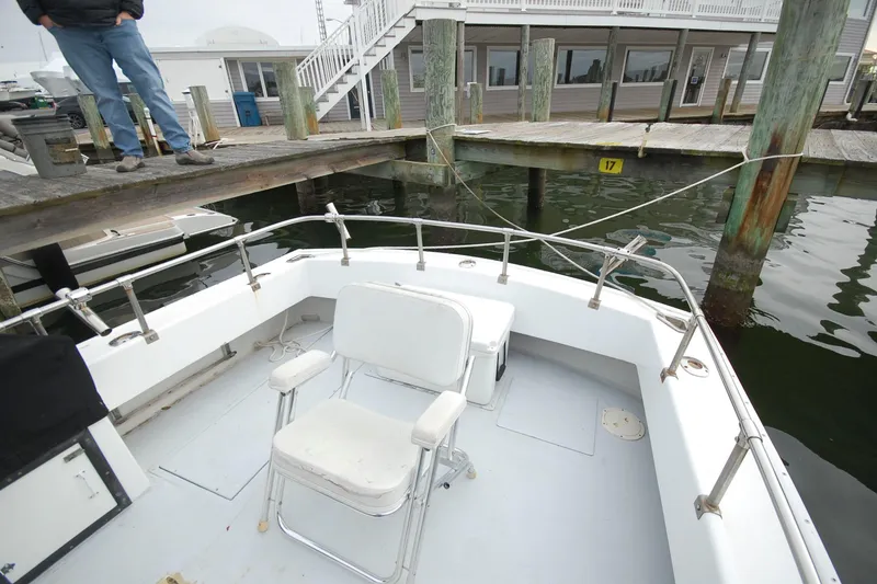 Slide: The Image of Custom Stan Haven 30 boat docked at marina, featuring a white deck and seating area. - 2