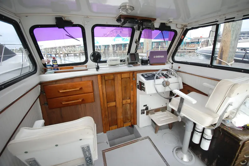 Slide: The Image of Interior of 1998 Custom Stan Haven 30 boat with steering wheel and navigation equipment. - 5