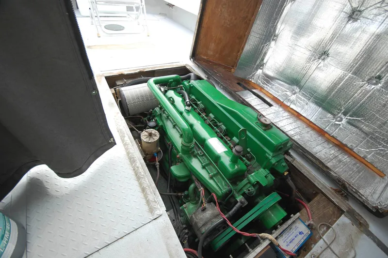 Slide: The Image of Green engine inside a 1998 Custom Stan Haven 30 boat, with open hatch and insulation. - 9