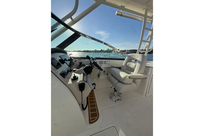 Slide: The Image of 2020 Boston Whaler 270 Vantage helm with luxurious seating and scenic water view. - 11