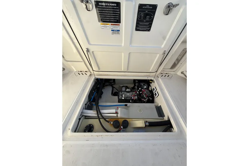 Slide: The Image of 2020 Boston Whaler 270 Vantage engine compartment with visible components and wiring. - 16