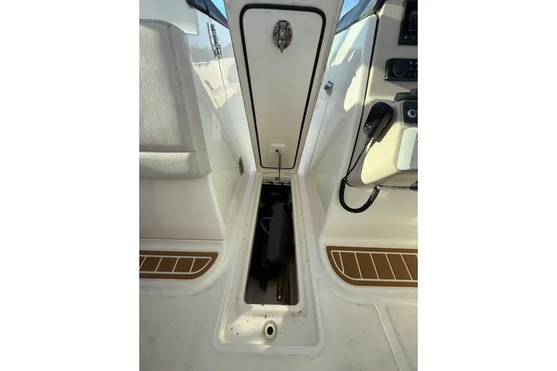 Slide: The Image of 2020 Boston Whaler 270 Vantage interior storage compartment with open hatch. - 18