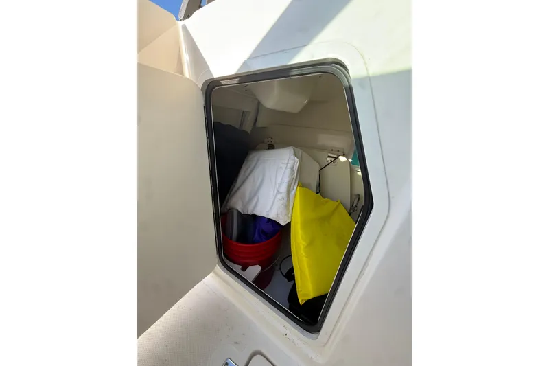 Slide: The Image of Storage compartment on a 2020 Boston Whaler 270 Vantage boat, containing various items. - 19