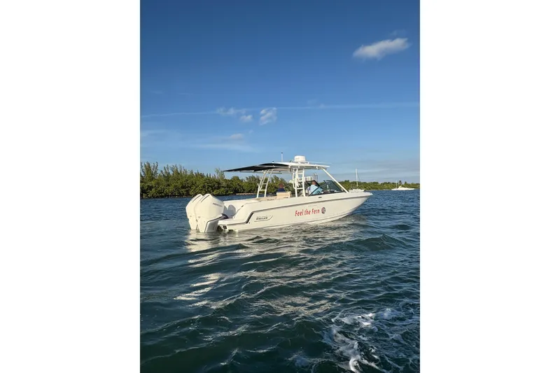 Slide: The Image of 2020 Boston Whaler 270 Vantage boat cruising on a sunny day. - 2