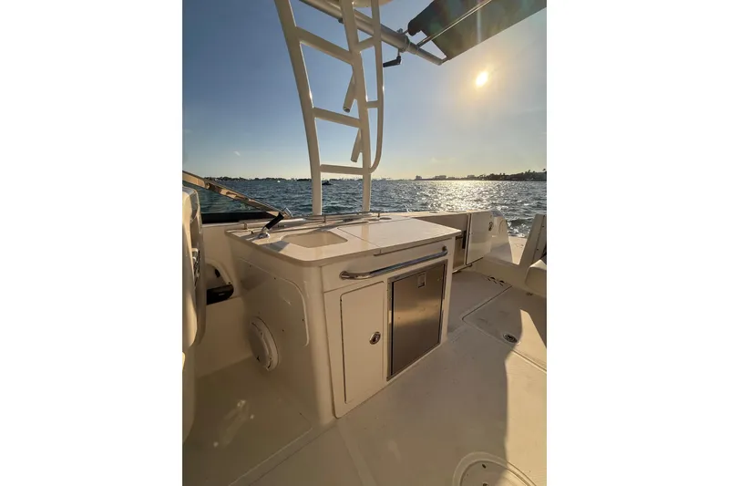 Slide: The Image of 2020 Boston Whaler 270 Vantage boat interior with ocean view at sunset. - 7