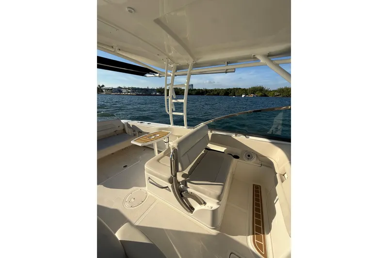 Slide: The Image of 2020 Boston Whaler 270 Vantage boat interior with seating and table on open water. - 9