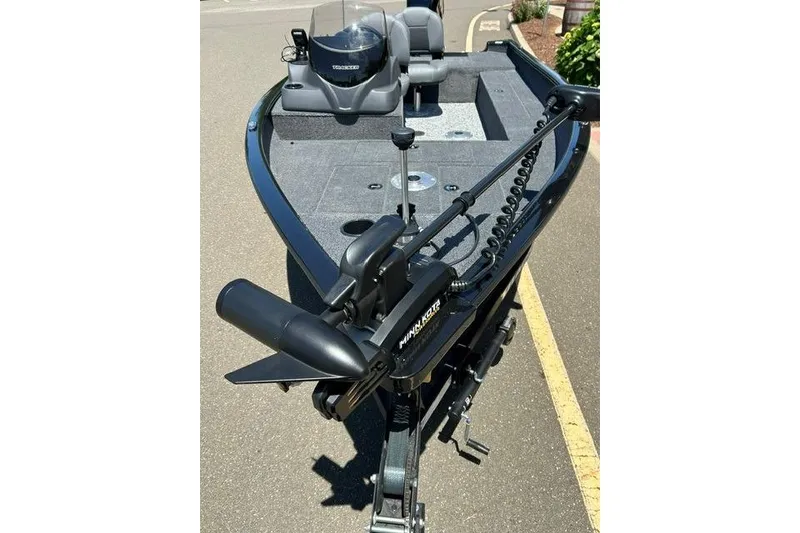 Slide: The Image of 2026 Tracker Super Guide V-16 SC boat with Minn Kota trolling motor on pavement. - 2