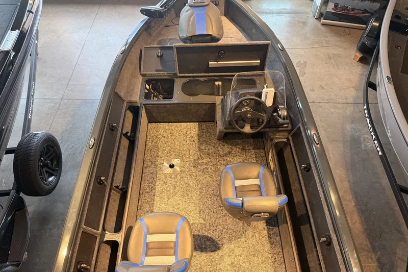 Slide: The Image of 2026 Ranger VS1665SC fishing boat interior with steering console and seating. - 7