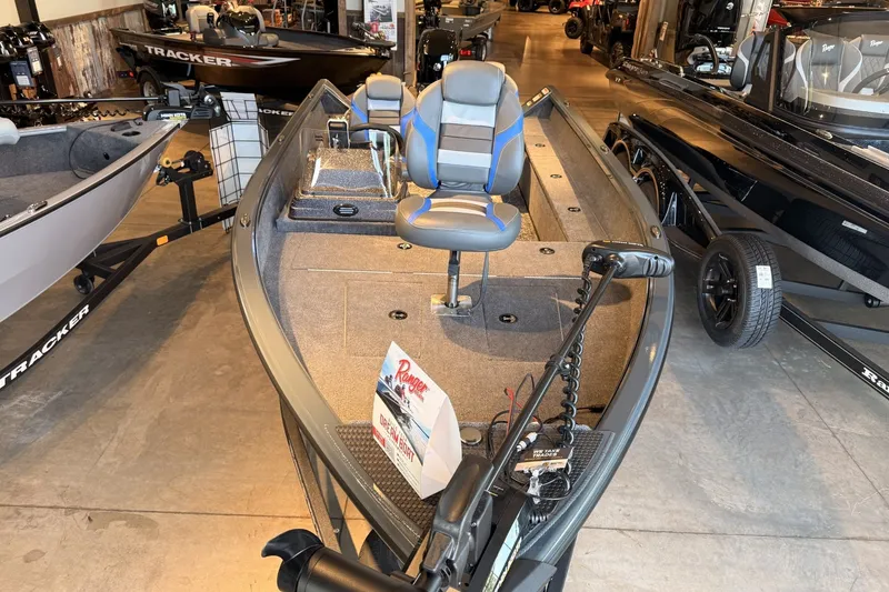 Slide: The Image of 2026 Ranger VS1665SC fishing boat displayed in showroom with seating and equipment. - 3