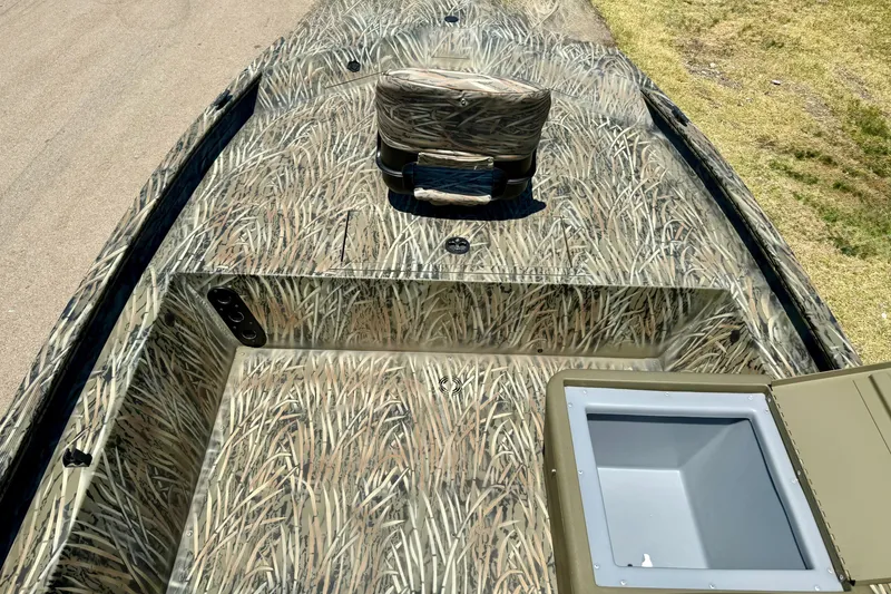 Slide: The Image of 2026 Tracker Grizzly 1754 SC boat with camouflage design, featuring a spacious deck and storage compartment. - 13
