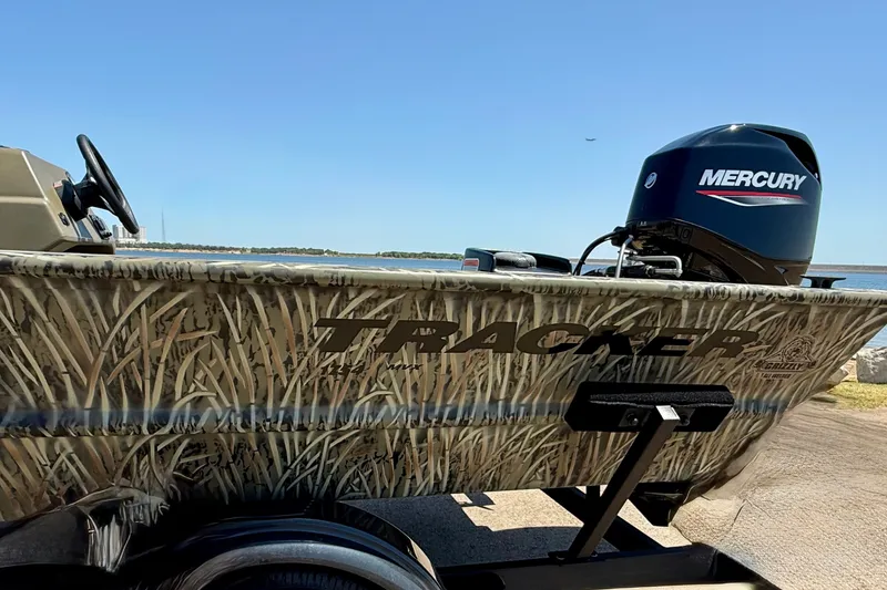 Slide: The Image of 2026 Tracker Grizzly 1754 SC boat with camouflage design and Mercury outboard motor. - 17