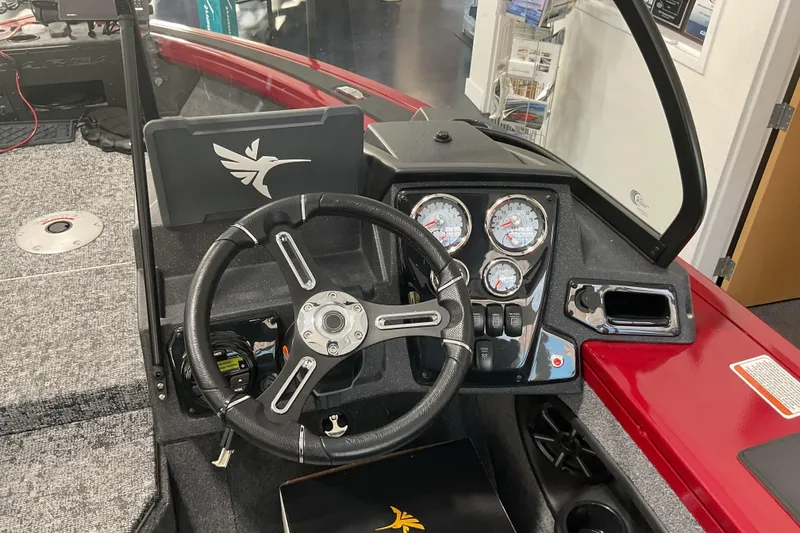 Slide: The Image of 2026 Tracker Targa V-19 Combo boat dashboard with steering wheel and gauges. - 8