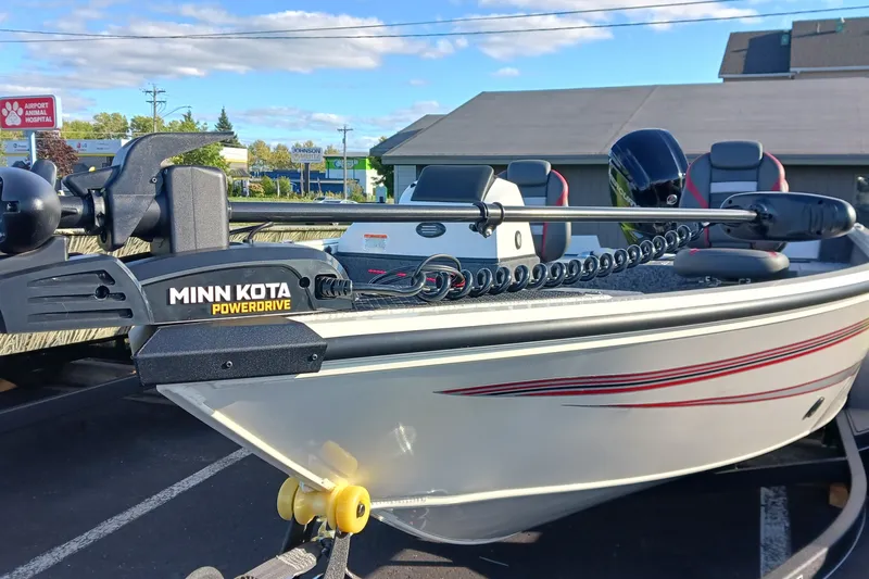 Slide: The Image of 2026 Ranger VS1682SC Angler boat with Minn Kota PowerDrive motor in parking lot. - 1