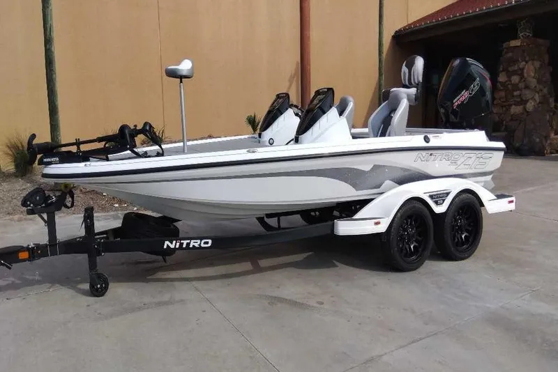 The Image of 2026 Nitro Z19 XL boat on trailer, white with gray accents, parked outdoors. - 0